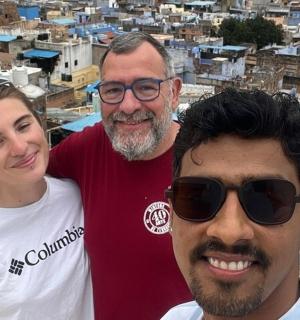 a group of people posing for a picture on top of a city