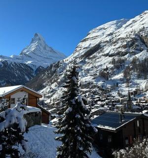 a snow covered mountain with a town in front of it