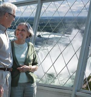 a man and a woman standing in front of a window