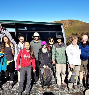 a group of people standing in front of a van