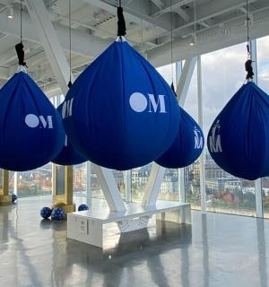 a group of blue containers hanging from a building