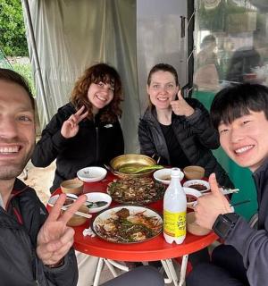 一群人围坐在桌旁吃饭