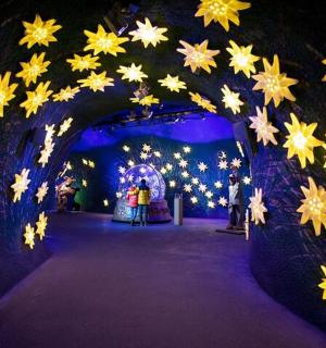 a tunnel filled with yellow and white stars