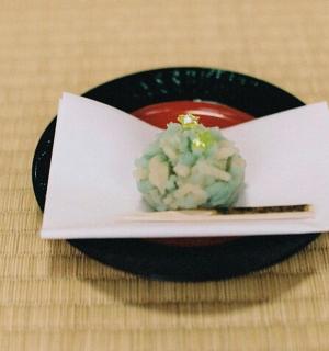 a plate of food with a bowl of rice and chopsticks