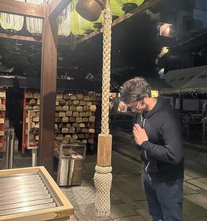 a man is standing in front of a store