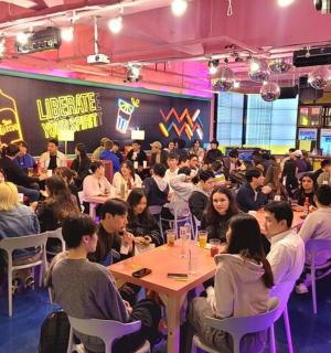 a crowd of people sitting at tables in a room