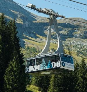 a gondola flying over a mountain
