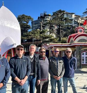 a group of men standing in front of a building