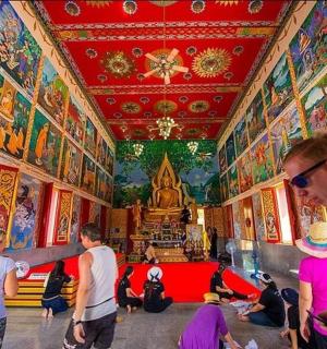 a group of people in a room with paintings on the walls