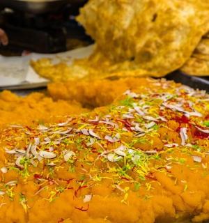 a pizza sitting on top of a table with toppings