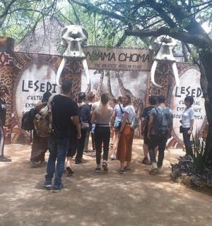 一群人走在一扇挂满骷髅的大门前