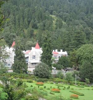 a large white house in the middle of a park