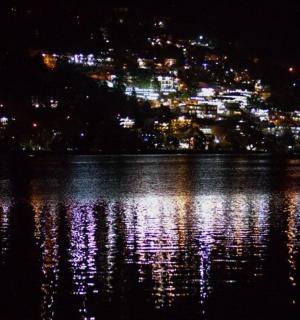 a view of a lake at night with a city