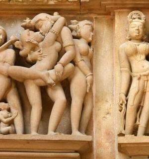 a stone wall with a bunch of statues on it