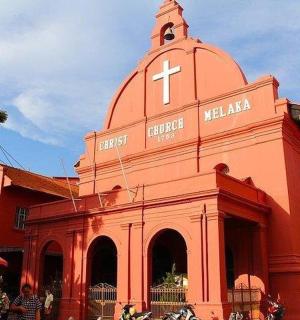 a red church with a cross on top of it