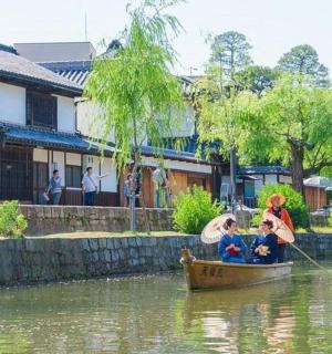 a woman and two children in a boat on a river