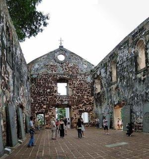a group of people walking around an old building