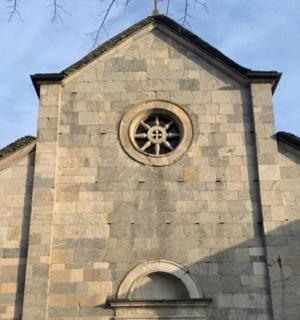 a church with a clock on the side of it