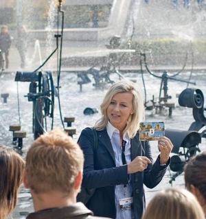 a woman standing in front of a crowd of people
