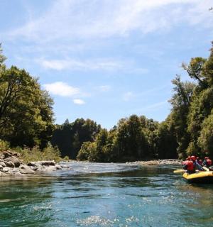a group of people in a raft on a river
