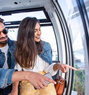 a man and woman on a train looking out the window