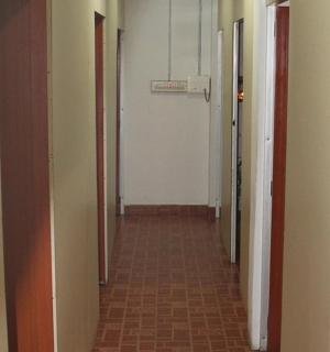 a hallway with many doors and a tile floor