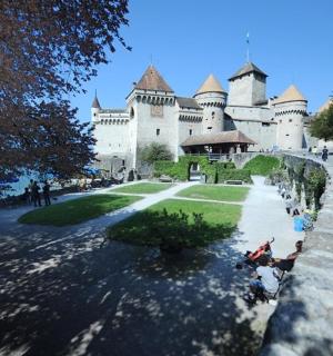 a castle with people sitting in front of it