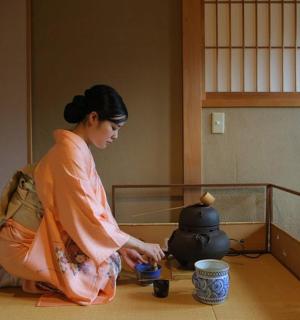 a woman sitting on the floor in a room with a pot