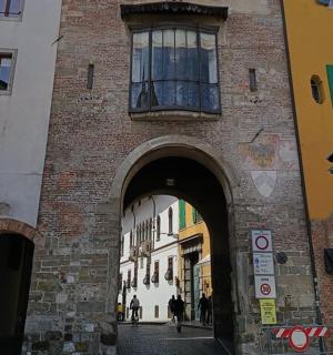 a brick building with an archway in a street