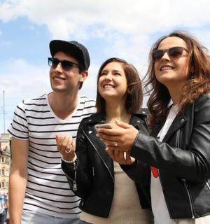a man and two women standing next to each other