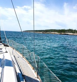 a boat in the water near a small island