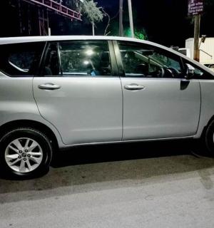 a silver car parked on the side of a street