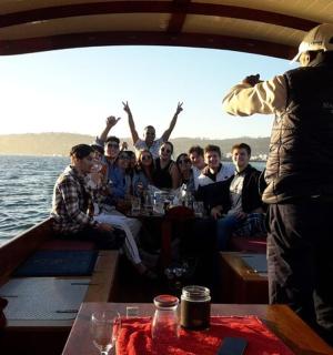 a man standing on a boat with a group of people