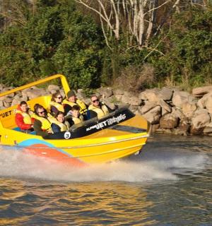 一群人坐在水上的黄色小船上