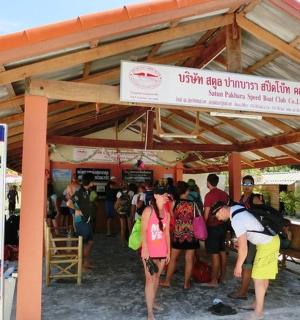 a group of people are standing under a pavilion