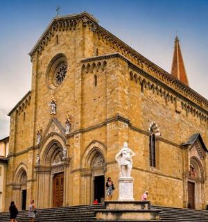 a large brick building with a statue in front of it