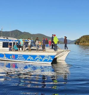 a group of people on a boat in the water