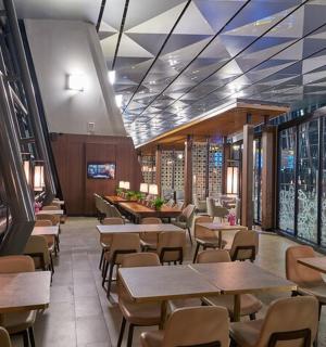 a restaurant with wooden tables and chairs and tablesearcher