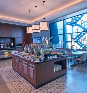 a kitchen and dining room with a counter with food on it