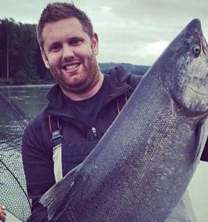 a man holding a large fish in his hand