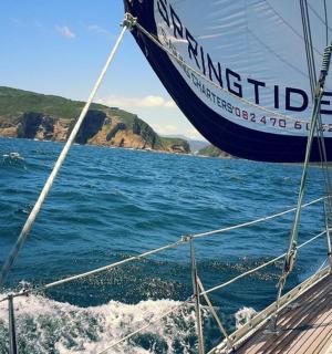 a boat in the water with a mountain in the background