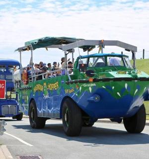 a bus with people riding in a boat