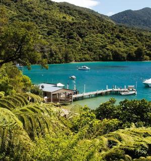two boats are docked at a dock in a lake