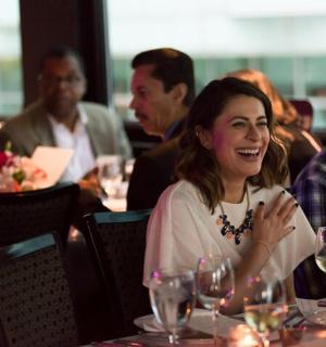 a group of people sitting at a table with wine glasses