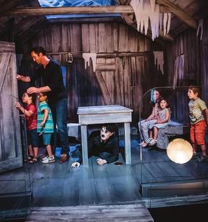 a group of children standing in a room on a stage