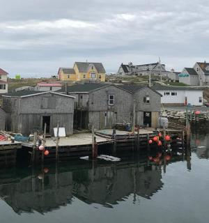 a group of houses on the water next to a dock