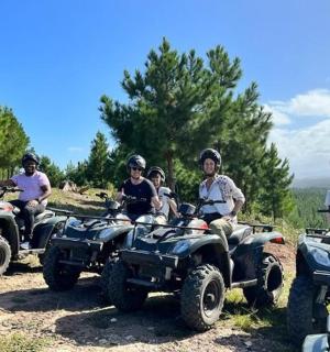 a group of people riding atvs on a dirt road