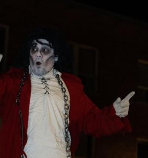 a man dressed as a joker with his arms outstretched