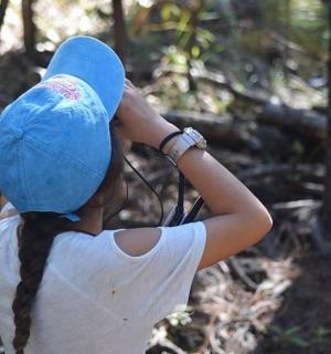 a woman wearing a blue hat with a ponytail
