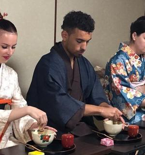 a group of three people sitting at a table eating food